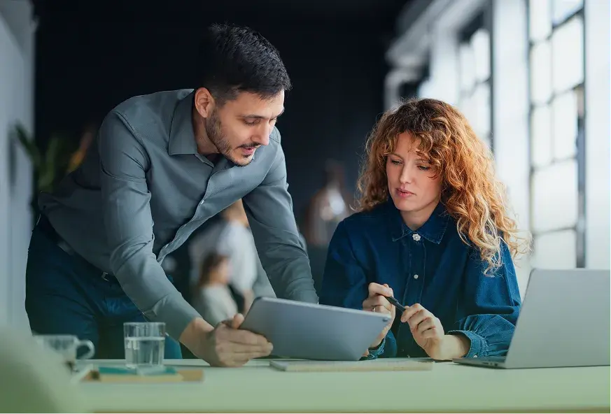 A broker and a CDB advisor reviewing plan details on a tablet