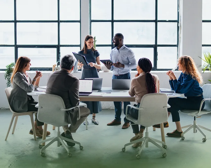 Custom Design Benefits members collaborating around a conference table