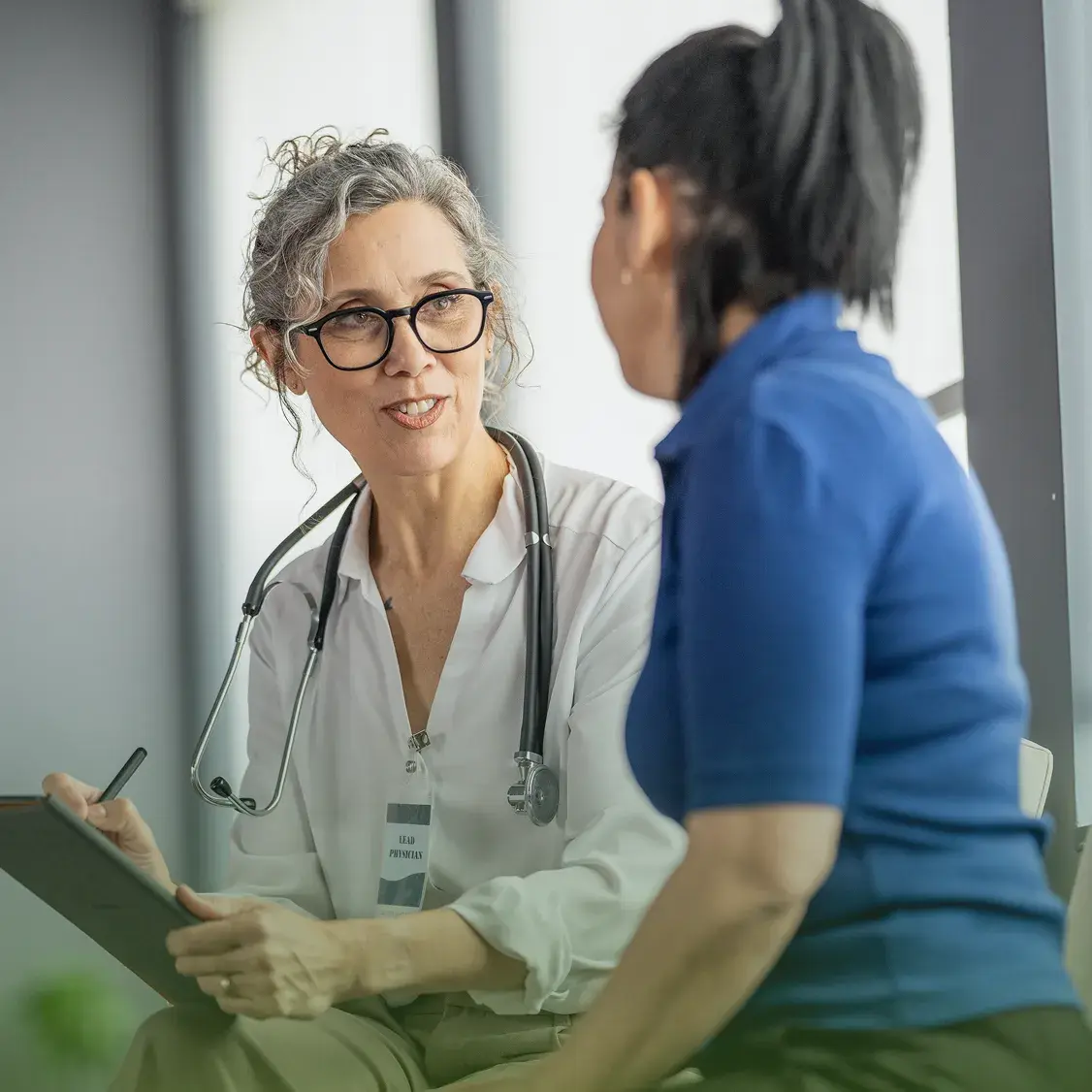 A physician talking with a patient during a consultation